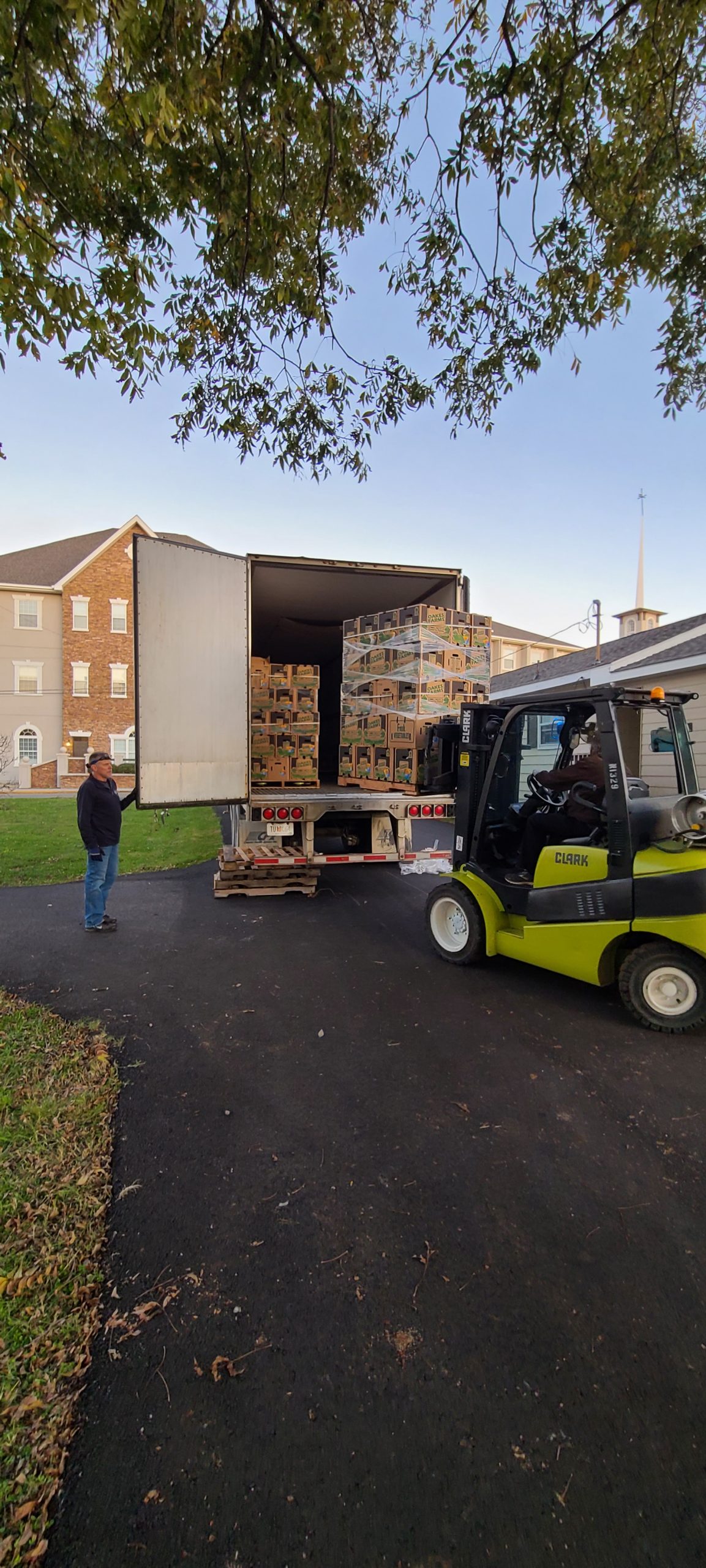 Forklift taking boxes out of a delivery truck