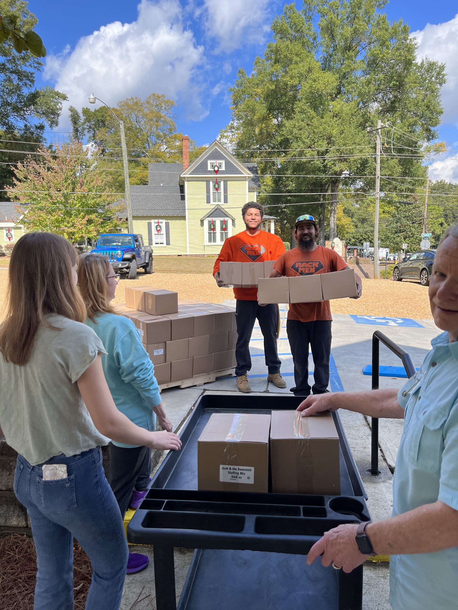 Volunteers carrying boxes into Red Door Food Pantry